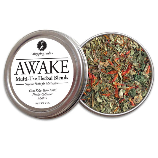 Open metal tin of 'AWAKE' multi-use herbal blends with gotu kola, yerba mate, nettles and safflower on a white background