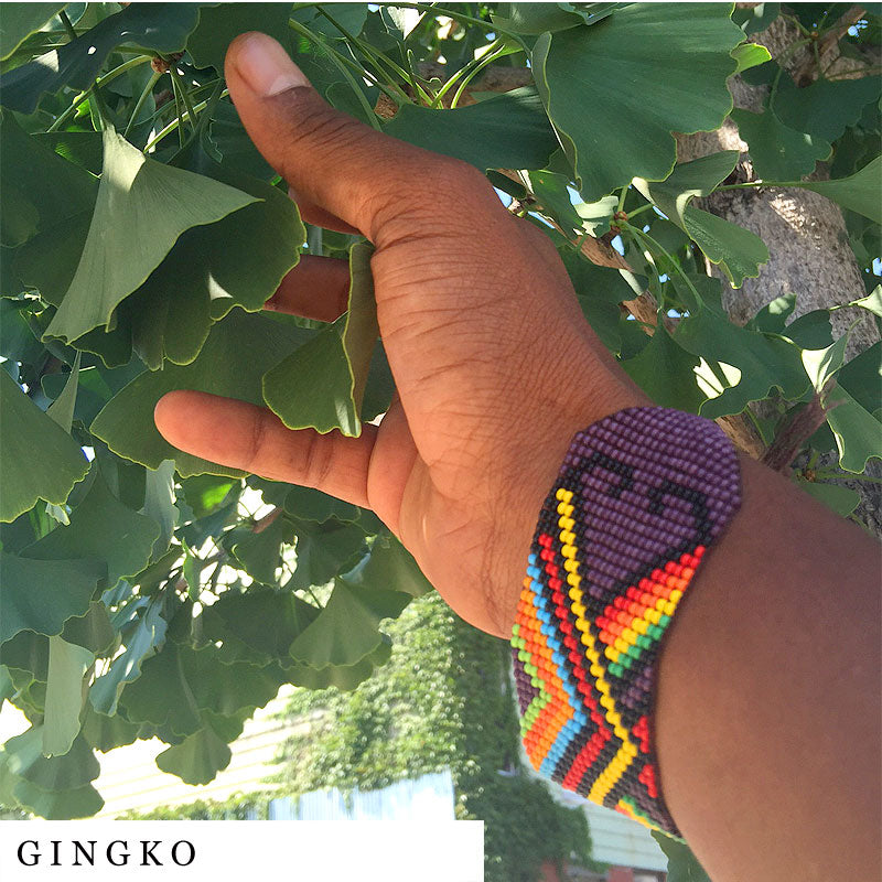 Brown hand picking fresh ginkgo leaves from tree – ingredient in FOCUS blend