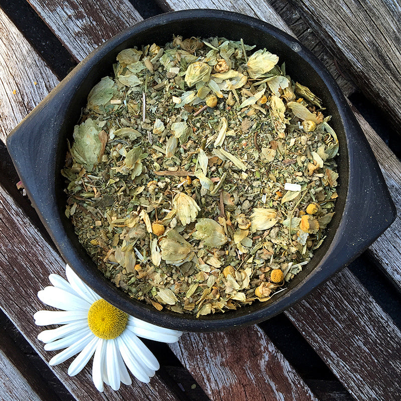 Earth-toned bowl of hops and catnip blend with daisy flower – RELAX herbal mix