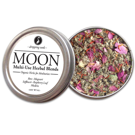 Metal tin with 'MOON' multi-use herbal blends with rose, mugwort, safflower, raspberry leaf and mullein on a white background