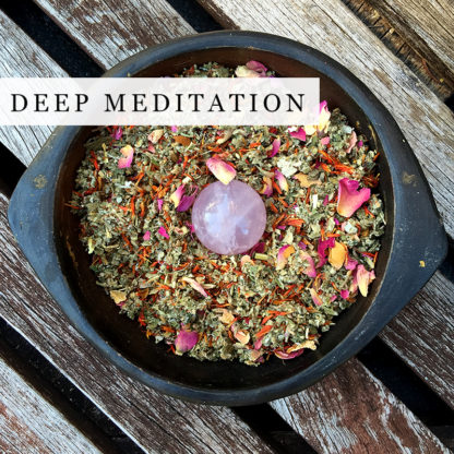 A blend of organic herbs in a black bowl for deep meditation
