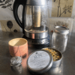 Herbal infusion tea pot with pink tea cup